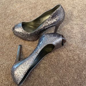 Barely worn sparkly silver Guess high heels. Size 7